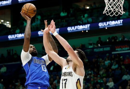 Naji Marshall #13 of the Dallas Mavericks shoots over Karlo Matković #17 of the New Orleans Pelicans during the first half at Smoothie King Center on March 16, 2026.