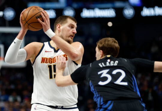 Denver Nuggets star Nikola Jokić dribbles as Dallas Mavericks rookie Cooper Flagg defends during the first half on December 23, 2025 in Dallas.
