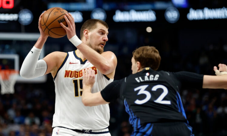 Denver Nuggets star Nikola Jokić dribbles as Dallas Mavericks rookie Cooper Flagg defends during the first half on December 23, 2025 in Dallas.
