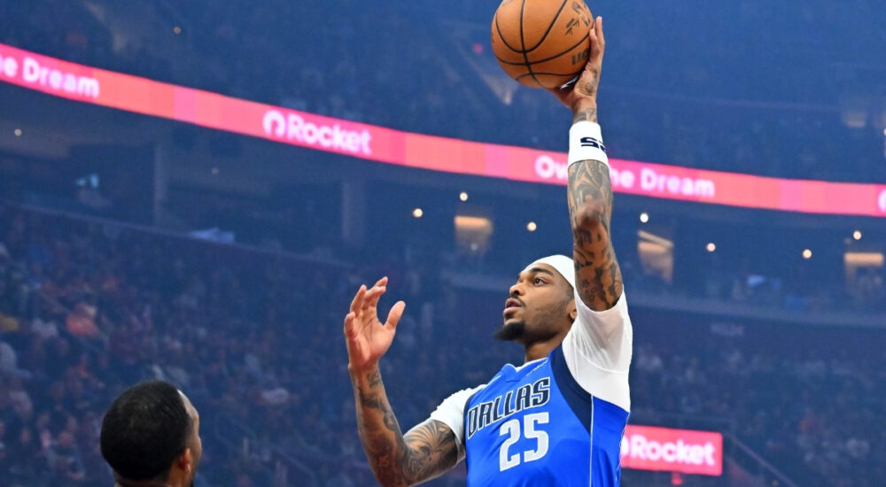 P.J. Washington Jr. #25 of the Dallas Mavericks shoots over Dean Wade #32 and Evan Mobley #4 of the Cleveland Cavaliers during the first quarter at Rocket Arena on March 15, 2026 in Cleveland, Ohio.