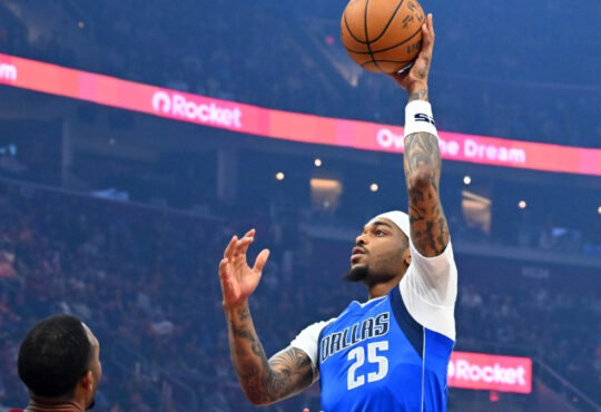 P.J. Washington Jr. #25 of the Dallas Mavericks shoots over Dean Wade #32 and Evan Mobley #4 of the Cleveland Cavaliers during the first quarter at Rocket Arena on March 15, 2026 in Cleveland, Ohio.