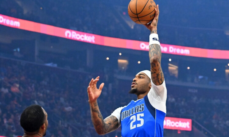 P.J. Washington Jr. #25 of the Dallas Mavericks shoots over Dean Wade #32 and Evan Mobley #4 of the Cleveland Cavaliers during the first quarter at Rocket Arena on March 15, 2026 in Cleveland, Ohio.