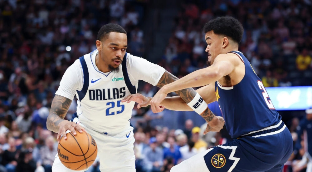 P.J. Washington (#25) of the Dallas Mavericks drives to the basket against the Denver Nuggets during the first quarter at Ball Arena.