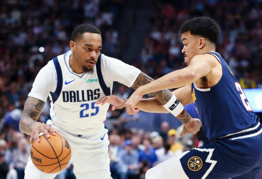 P.J. Washington (#25) of the Dallas Mavericks drives to the basket against the Denver Nuggets during the first quarter at Ball Arena.