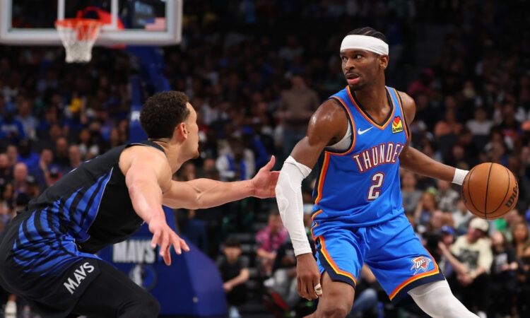 NBA: Shai Gilgeous-Alexander drives to the basket while defended by Dwight Powell at American Airlines Center during Thunder vs. Mavericks.