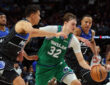 Cooper Flagg #32 of the Dallas Mavericks drives to the basket between Orlando Magic's Tristan da Silva and Desmond Bane during a historic 51-point game at American Airlines Center.