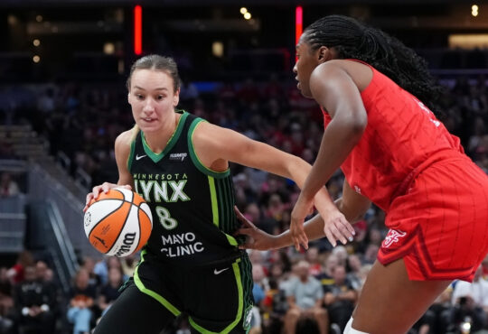 Dallas Wings forward Alanna Smith handling the ball while being guarded by Aliyah Boston of the Indiana Fever at Gainbridge Fieldhouse.