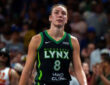 Alanna Smith wearing a Minnesota Lynx jersey walking on the court during a 2025 game against the Atlanta Dream.