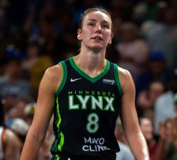 Alanna Smith wearing a Minnesota Lynx jersey walking on the court during a 2025 game against the Atlanta Dream.