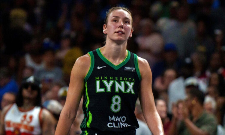 Alanna Smith wearing a Minnesota Lynx jersey walking on the court during a 2025 game against the Atlanta Dream.