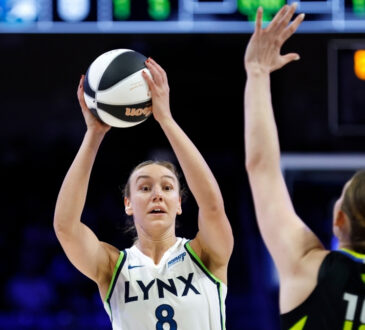 Alanna Smith #8 of the Minnesota Lynx looks to pass the ball while guarded by the Dallas Wings at College Park Center.