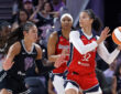 Washington Mystics forward Alysha Clark looks for a passing lane while guarded by Veronica Burton of the Golden State Valkyries.