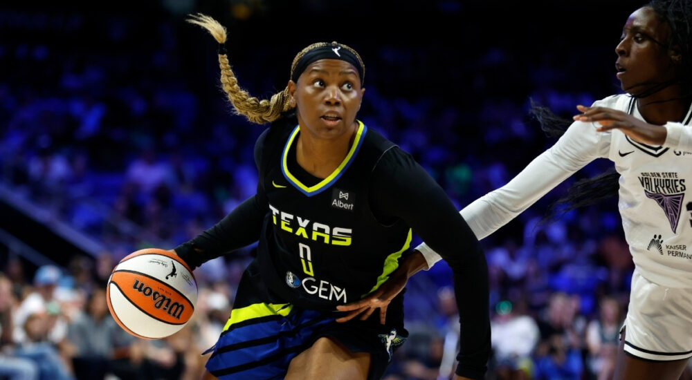Amy Okonkwo #0 of the Dallas Wings drives against Laeticia Amihere #3 of the Golden State Valkyries at College Park Center.