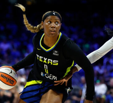 Amy Okonkwo #0 of the Dallas Wings drives against Laeticia Amihere #3 of the Golden State Valkyries at College Park Center.