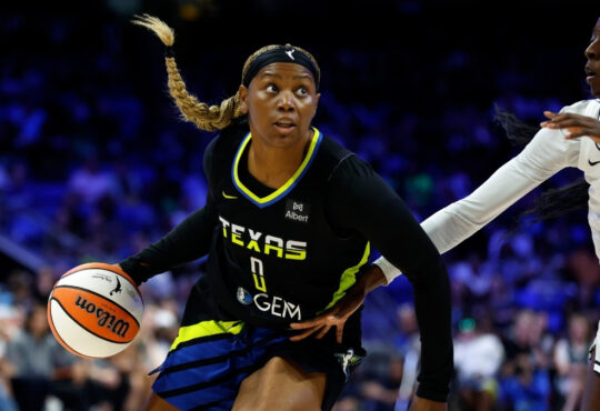 Amy Okonkwo #0 of the Dallas Wings drives against Laeticia Amihere #3 of the Golden State Valkyries at College Park Center.
