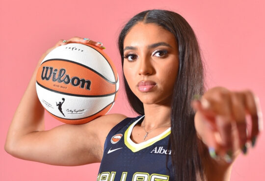 Azzi Fudd of the Dallas Wings poses in her home white uniform during her introductory press conference in Arlington, Texas.