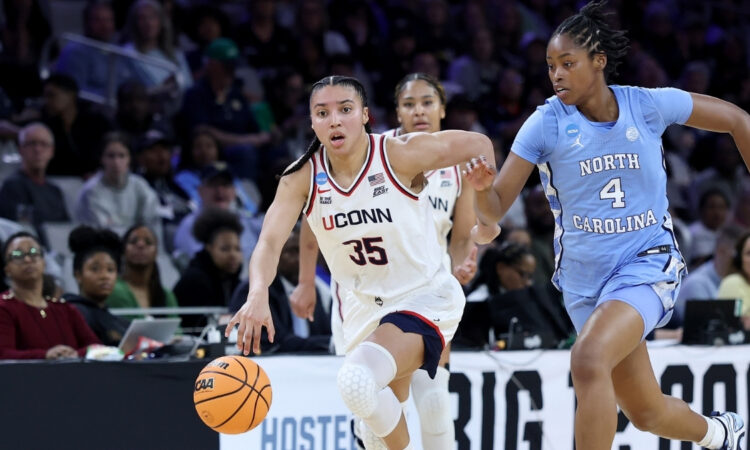 Azzi Fudd #35 of the UConn Huskies dribbles against Laila Hull of North Carolina during the NCAA Sweet Sixteen at Dickies Arena in Fort Worth.