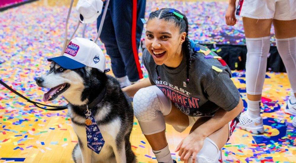 Azzi Fudd #35 of the UConn Huskies poses with Jonathan the Husky mascot after winning the Big East Tournament championship against Villanova.