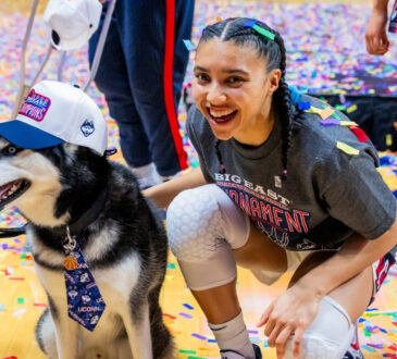 Azzi Fudd #35 of the UConn Huskies poses with Jonathan the Husky mascot after winning the Big East Tournament championship against Villanova.