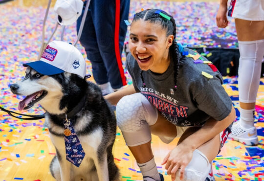 Azzi Fudd #35 of the UConn Huskies poses with Jonathan the Husky mascot after winning the Big East Tournament championship against Villanova.