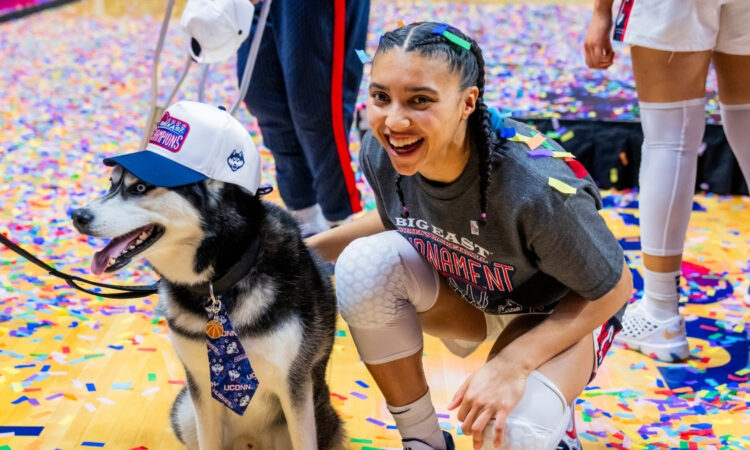 Azzi Fudd #35 of the UConn Huskies poses with Jonathan the Husky mascot after winning the Big East Tournament championship against Villanova.