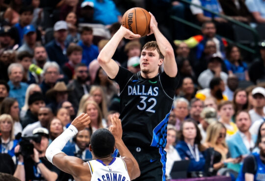 Cooper Flagg #32 of the Dallas Mavericks shooting a jump shot over Rui Hachimura #28 of the Los Angeles Lakers at American Airlines Center.