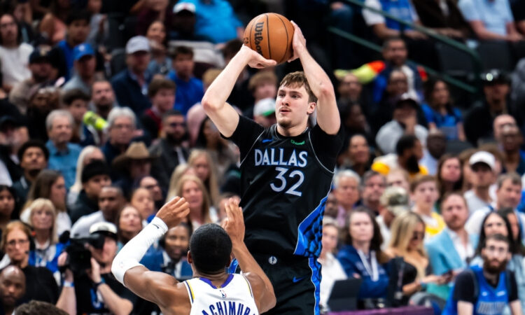 Cooper Flagg #32 of the Dallas Mavericks shooting a jump shot over Rui Hachimura #28 of the Los Angeles Lakers at American Airlines Center.