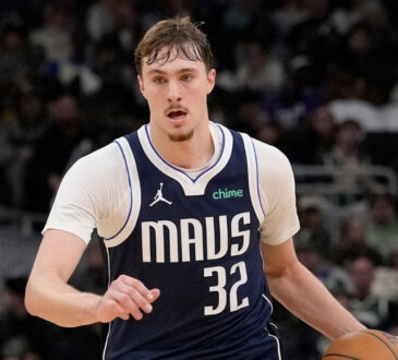 Cooper Flagg #32 of the Dallas Mavericks brings the ball up the court against the Milwaukee Bucks at Fiserv Forum.