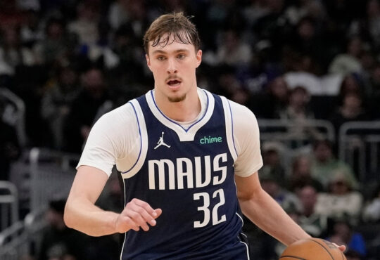 Cooper Flagg #32 of the Dallas Mavericks brings the ball up the court against the Milwaukee Bucks at Fiserv Forum.