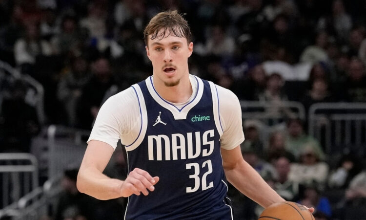 Cooper Flagg #32 of the Dallas Mavericks brings the ball up the court against the Milwaukee Bucks at Fiserv Forum.