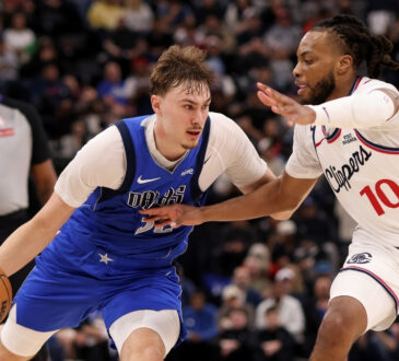 Cooper Flagg #32 of the Dallas Mavericks drives to the basket against Darius Garland #10 of the Los Angeles Clippers during the fourth quarter at Intuit Dome.