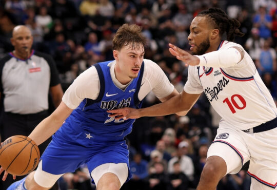 Cooper Flagg #32 of the Dallas Mavericks drives to the basket against Darius Garland #10 of the Los Angeles Clippers during the fourth quarter at Intuit Dome.