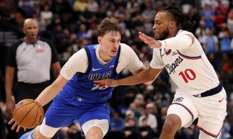 Cooper Flagg #32 of the Dallas Mavericks drives to the basket against Darius Garland #10 of the Los Angeles Clippers during the fourth quarter at Intuit Dome.