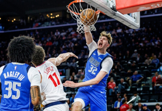 Cooper Flagg #32 of the Dallas Mavericks throws down a slam dunk over Brook Lopez #11 of the Los Angeles Clippers at Intuit Dome.