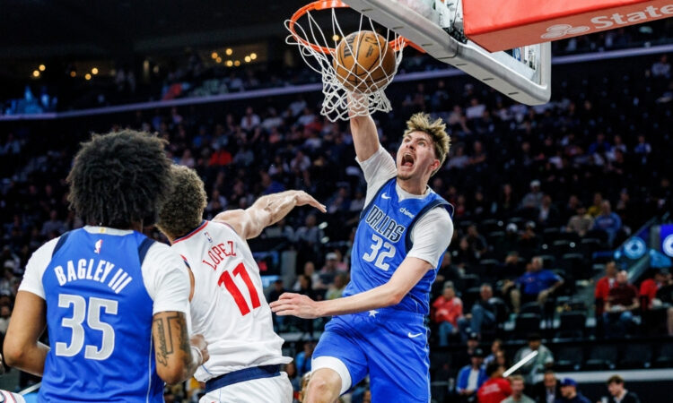 Cooper Flagg #32 of the Dallas Mavericks throws down a slam dunk over Brook Lopez #11 of the Los Angeles Clippers at Intuit Dome.