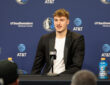 Cooper Flagg poses with the NBA Rookie of the Year trophy alongside head coach Jason Kidd at American Airlines Center.