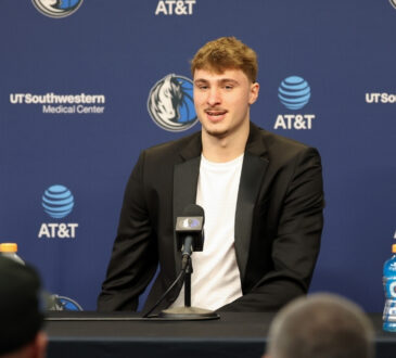 Cooper Flagg poses with the NBA Rookie of the Year trophy alongside head coach Jason Kidd at American Airlines Center.