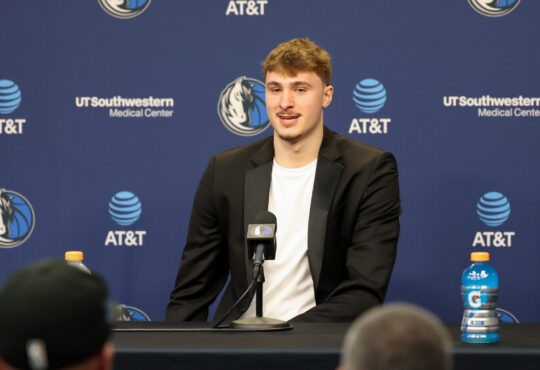 Cooper Flagg poses with the NBA Rookie of the Year trophy alongside head coach Jason Kidd at American Airlines Center.