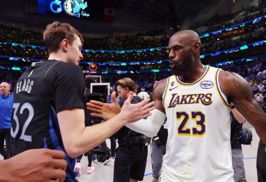 Cooper Flagg #32 of the Dallas Mavericks shakes hands with LeBron James #23 of the Los Angeles Lakers after a Mavericks win at American Airlines Center on April 5, 2026 in Dallas, Texas.