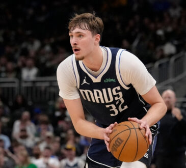 Cooper Flagg #32 of the Dallas Mavericks brings the ball up the court against the Milwaukee Bucks during the fourth quarter at Fiserv Forum on March 31, 2026.
