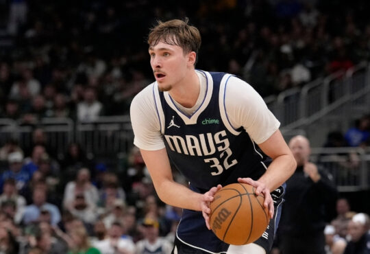 Cooper Flagg #32 of the Dallas Mavericks brings the ball up the court against the Milwaukee Bucks during the fourth quarter at Fiserv Forum on March 31, 2026.
