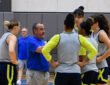 Dallas Wings head coach Jose Fernandez speaks to Paige Bueckers, Alysha Clark, Odyssey Sims, Li Yueru, and Maddy Siegrist during a training camp practice huddle at College Park Center.