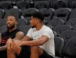 Damian Lillard #0 of the Portland Trail Blazers and Giannis Antetokounmpo #34 of the Milwaukee Bucks talk at Fiserv Forum on November 24, 2025.