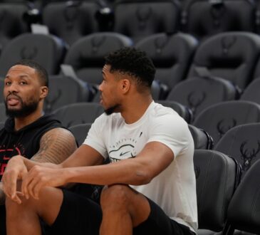 Damian Lillard #0 of the Portland Trail Blazers and Giannis Antetokounmpo #34 of the Milwaukee Bucks talk at Fiserv Forum on November 24, 2025.