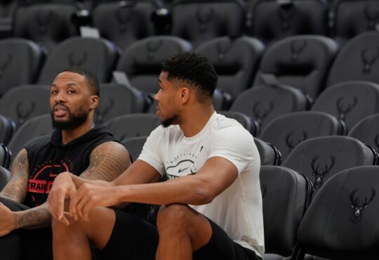 Damian Lillard #0 of the Portland Trail Blazers and Giannis Antetokounmpo #34 of the Milwaukee Bucks talk at Fiserv Forum on November 24, 2025.