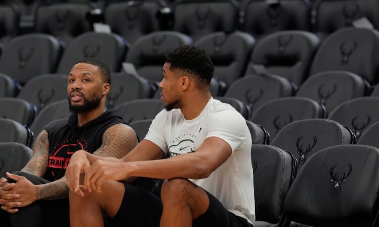 Damian Lillard #0 of the Portland Trail Blazers and Giannis Antetokounmpo #34 of the Milwaukee Bucks talk at Fiserv Forum on November 24, 2025.