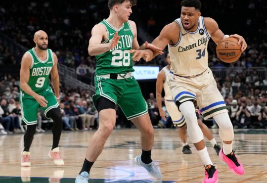 Giannis Antetokounmpo #34 of the Milwaukee Bucks dribbles against Hugo González #28 of the Boston Celtics at Fiserv Forum on March 02, 2026.