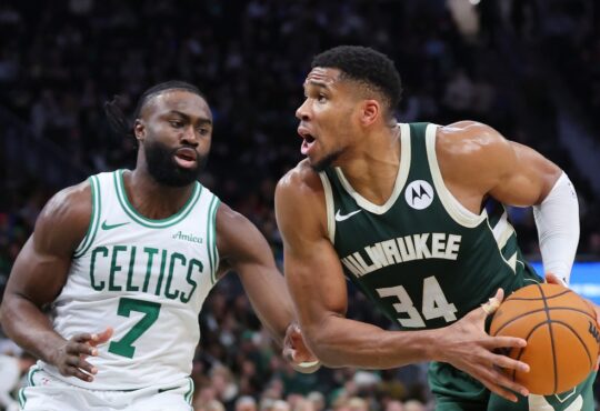 Giannis Antetokounmpo, a Celtics trade target, is defended by Boston's Jaylen Brown