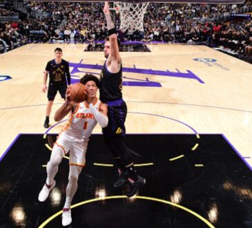 Jalen Johnson #1 of the Atlanta Hawks drives to the basket against Luka Doncic #77 of the Los Angeles Lakers at Crypto.com Arena on January 13, 2026.