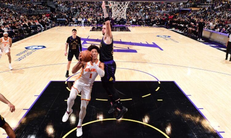 Jalen Johnson #1 of the Atlanta Hawks drives to the basket against Luka Doncic #77 of the Los Angeles Lakers at Crypto.com Arena on January 13, 2026.